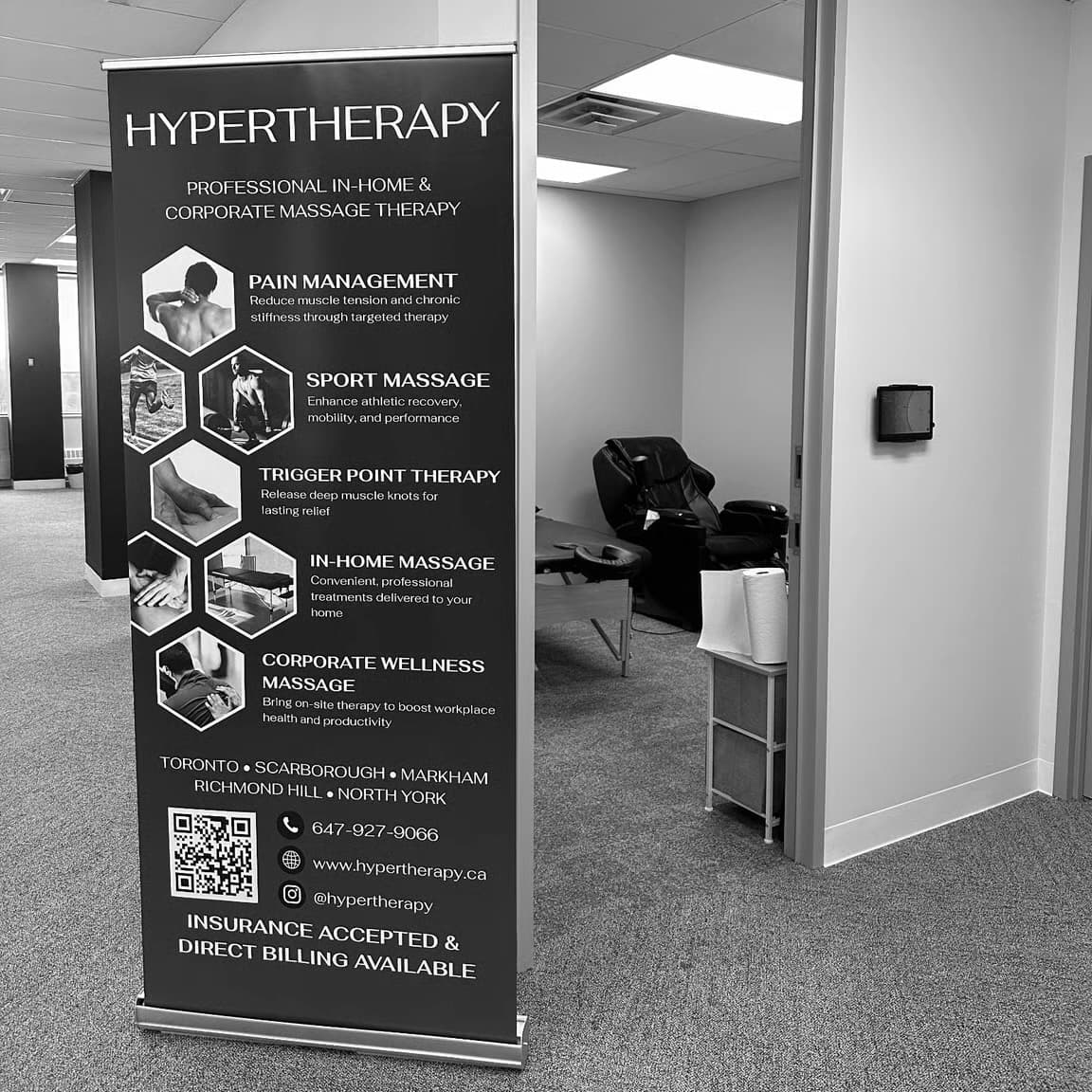 HyperTherapy banner and massage chair set up on-site at the Idealogical Group office