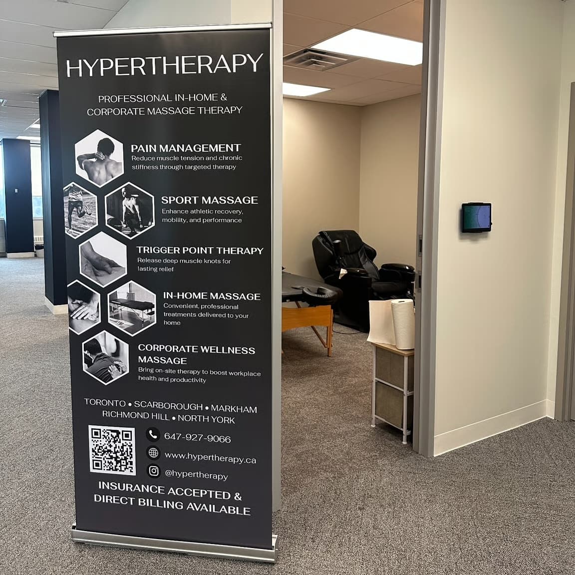 HyperTherapy banner and massage chair set up on-site at the Idealogical Group office