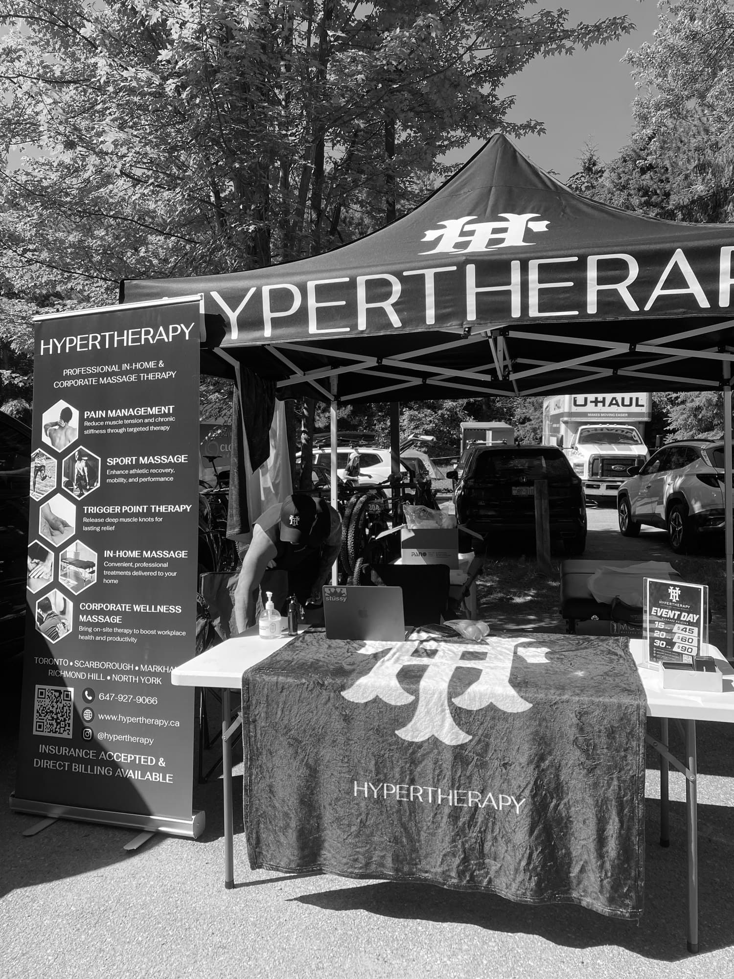 HyperTherapy's branded tent and chair massage station set up at a corporate event